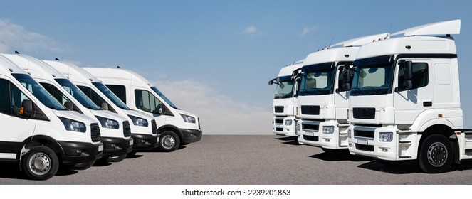 Semi trucks and delivery vans are parked in rows. Commercial fleet - Shutterstock ID 2239201863