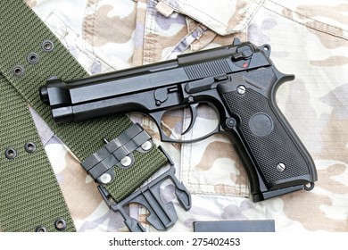 Semi-automatic Handgun On Camouflage Background, Gun On Military Texture, 9mm Pistol. 