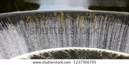 Semicircular spillway of hydropower plant built in 1919 on the Lame River in the villge Yaropolets and originally operated from the casting wheel of the mill. Volokolamsk. Summer 2015.