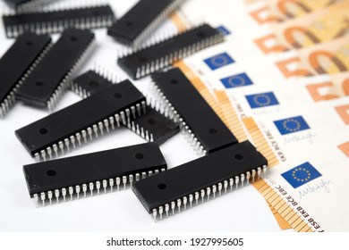 Semiconductor Chips Shortage And High Price. Pile Of Computer Chips And Spread Of Euro Banknotes. Concept For Crisis And Deficit In The Electronic Industry.