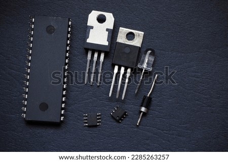 Semiconductor componenets. Integrated circuit, microchips, transistor, thyristor, voltage regulator,diode, and LED isolated on a black.