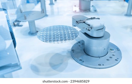 Semiconductor and Computer Chip Manufacturing at Fab or Foundry with robotic arms with silicon wafers 
