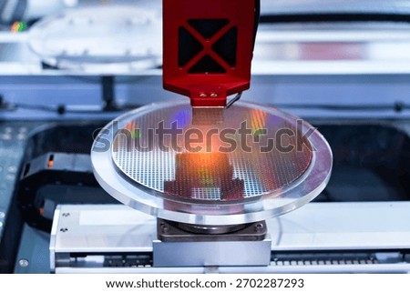 Semiconductor and Computer Chip Manufacturing at Fab or Foundry with robotic arms with silicon wafers 