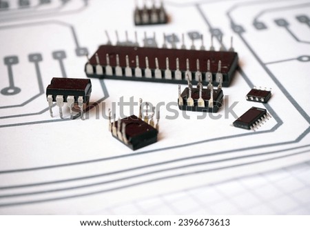 Semiconductor integrated circuits on the schematics. Engineering or hardware developer concept background. Selected focus.