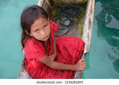 Semporna, Sabah, Malaysia - July 27, 2022 : Children Of Bajau Laut People Also Known As Sea Gypsies At Mabul Island In Sabah Riding A Wooden Canoe