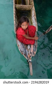 Semporna, Sabah, Malaysia - July 27, 2022 : Children Of Bajau Laut People Also Known As Sea Gypsies At Mabul Island In Sabah Riding A Wooden Canoe