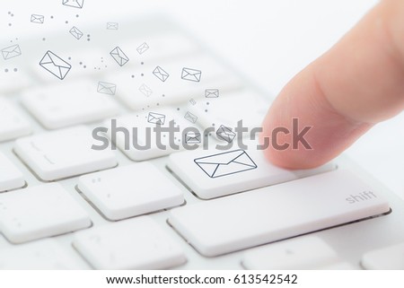Sending email. gesture of finger pressing send button on a computer keyboard - Selective Focus.
