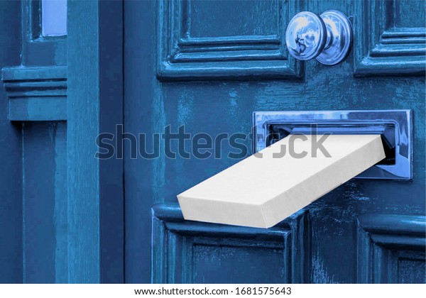 Sending a Gift In The Post.Postal white box\
the parcel is delivered through the parcel door opening.White post\
box and old aged grunge blue wooden\
door.