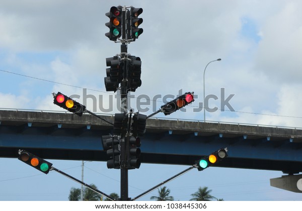 Sending Mixed Signals - Confusing Traffic Light at\
an intersection in central    Trinidad with multiple lights\
flashing all day all the time. No one knows what was the purpose of\
these multiple lights