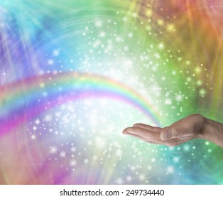 Sending Rainbow Healing  - Male hand palm up with a rainbow appearing to end in his palm on a rainbow colored background with glittering sparkles and swirling energy