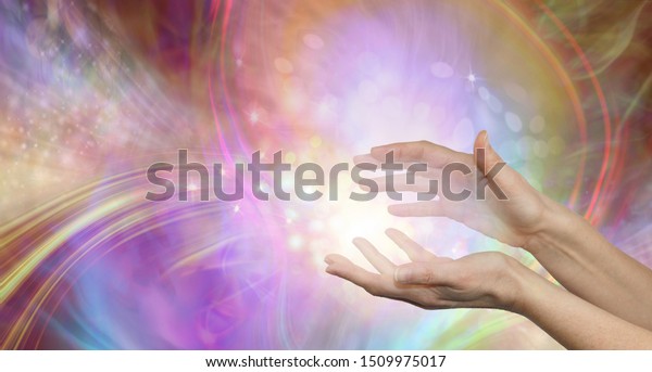 Sending you beautiful\
healing energy vibes - female cupped hands with white energy\
formation flowing outwards, sparkles and colours moving in all\
directions with copy\
space\
