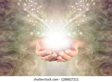 Sending You High Resonance Healing Energy - female cupped hands emerging from a green gold swirling energy field background with shimmering sparkles and white light flowing outwards
                  - Shutterstock ID 1288827211