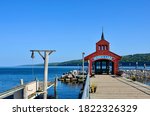 Seneca Lake as one of Finger Lakes in New York. Beautiful lakeshore scenery, early fall in a blue sky. Today’s waterfront visitors enjoy a picturesque view from the iconic Pier House at Watkins Glen.