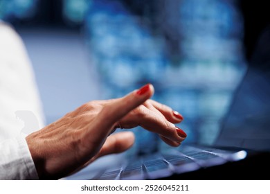 Senescent worker using laptop, setting up high bandwidth dedicated multiplayer gaming servers in high tech workspace to accommodate more traffic from worldwide locations and avoid low ping, close up