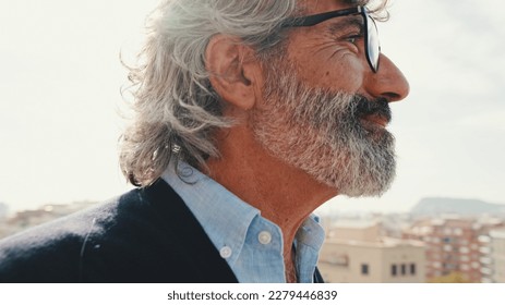 Senier enjoys the view standing on the balcony - Powered by Shutterstock