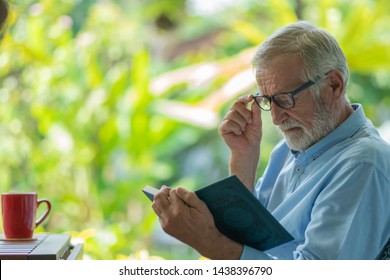 Senioe Man Reading A Book At Home -Image