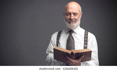 Senior Academic Professor Smiling And Holding An Old Book, Education And Knowledge Concept