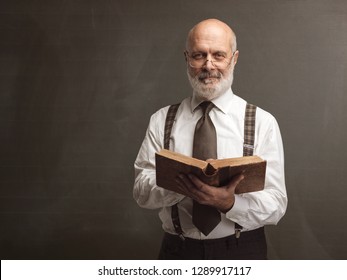 Senior Academic Professor Smiling And Holding An Old Book, Education And Knowledge Concept