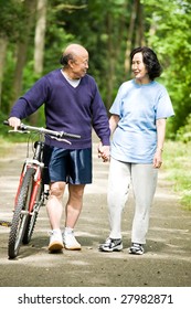 A Senior Active Asian Couple Walking And Exercise At The Park