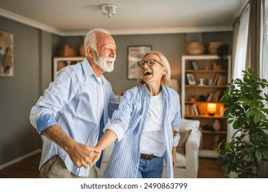 Senior active couple husband and wife dance and enjoy together at home - Powered by Shutterstock