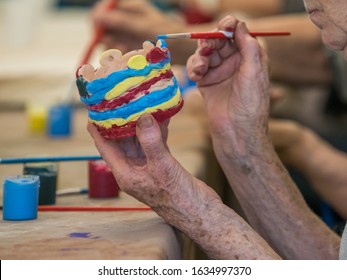 Senior activity concept. Workshop for clay sticking for seniors, glazing and painting clay figurines. Poland. - Shutterstock ID 1634997370