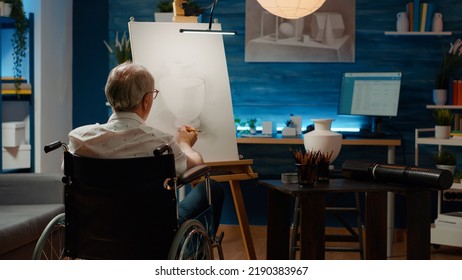 Senior Adult With Chronic Impairment Using Pencils To Draw Vase Model, Creating Professional Artwork Sketch With Creative Skills. Wheelchair User With Disability Drawing Masterpiece.