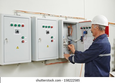 senior adult electrician builder engineer testing equipment in fuse box - Powered by Shutterstock