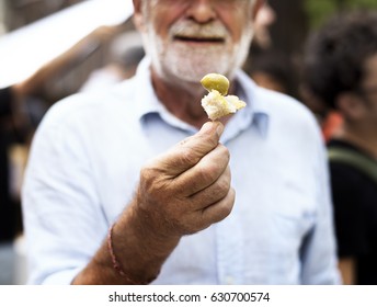 Senior Adult Man Showing Bread With Preserve Olive Sample Test