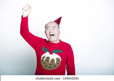 Senior Adult Man Wearing Christmas Jumper Raising His Arm In The Air