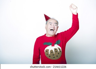 Senior Adult Man Wearing Christmas Jumper Raising His Arm In The Air