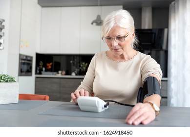 Senior Adult Woman Measuring Blood Pressure At Home