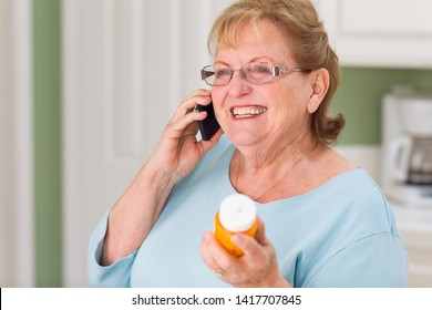 Senior Adult Woman On Cell Phone Holding Prescription Bottle.