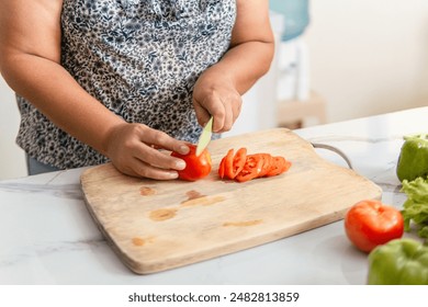 Senior adult woman preparing a meal in the kitchen. - Powered by Shutterstock