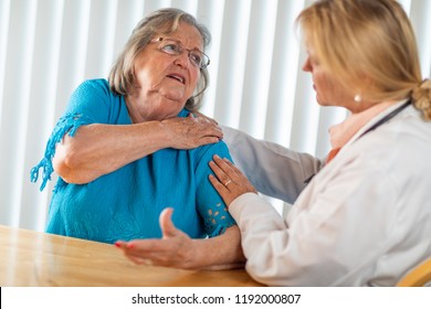 Senior Adult Woman Talking With Female Doctor About Sore Shoulder.