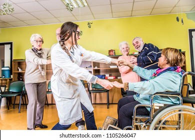 Senior Adults In A Nursing Home For The Elderly Having Fun And Dancing