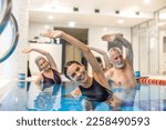 Senior adults in the swimming pool during aqua aerobics class