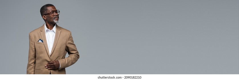 senior african american businessman in formal wear and eyeglasses looking away isolated on grey, banner - Shutterstock ID 2090182210