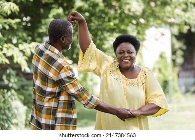 Senior African American Couple Dancing And Smiling In Park