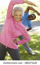 Senior African American Couple Exercising In Park