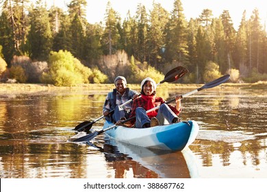 Senior African American Couple Rowing Kayak On Lake