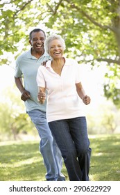 Senior African American Couple Running In Park