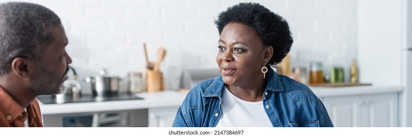 Senior African American Couple Talking In Kitchen, Banner