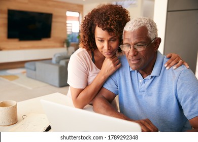 Senior African American Couple Using Laptop To Check Finances At Home