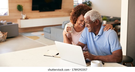 Senior African American Couple Using Laptop To Check Finances At Home