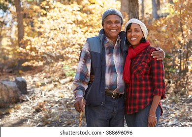 Senior African American Couple Walking Through Fall Woodland