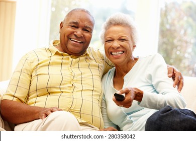 Senior African American couple watching TV