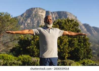 Senior african american man exercising outdoors in stunning countryside. retirement retreat and active senior lifestyle concept. - Powered by Shutterstock