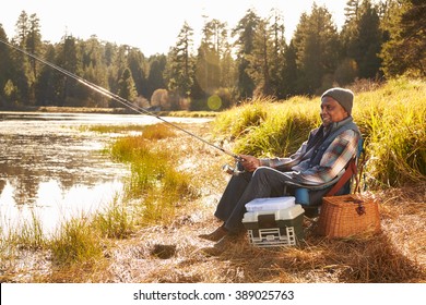 Senior African American Man Fishing By Lake