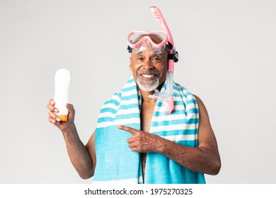 Senior African American Man Holding A Sunscreen Lotion Bottle