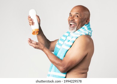 Senior African American Man Holding A Sunscreen Lotion Bottle